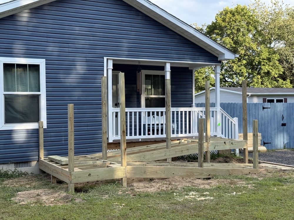 Porch framing and decking at a blue-sided home