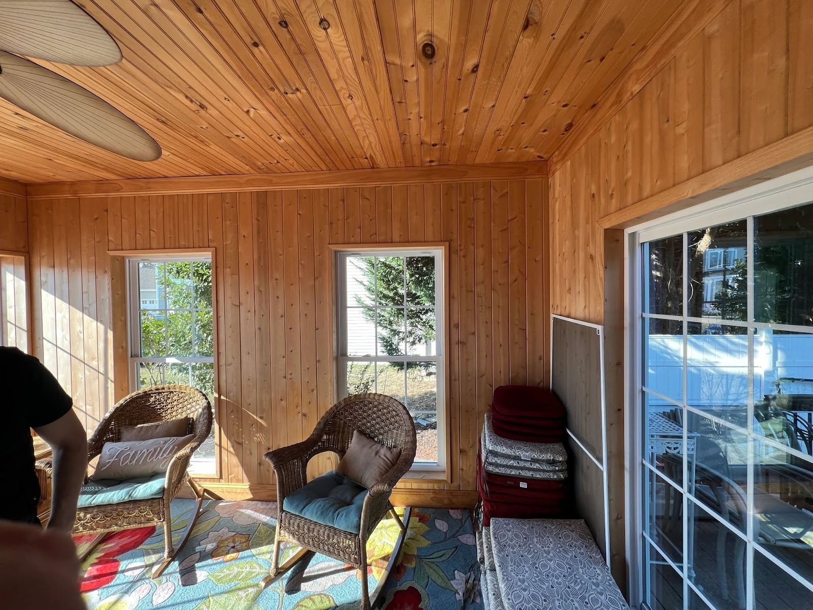 Sunroom with wood walls and ceiling and large windows
